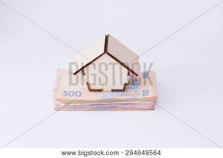 Uah Hryvnia Banknotes With Wooden House Isolated On White Background. Ukrainian Money. Concept Of Mo