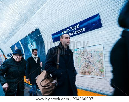 Paris, France - Mar 19, 2019: Group Of Commuters People Walking Inside Paris Metro At The Palais Roy
