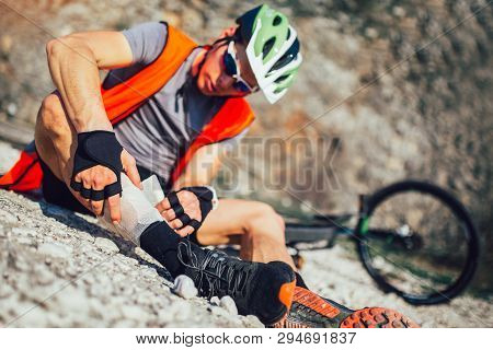 The Biker Fell From A Bike, Using A Bandage From His First Aid Kit To Help Himself. Bicycle Accident
