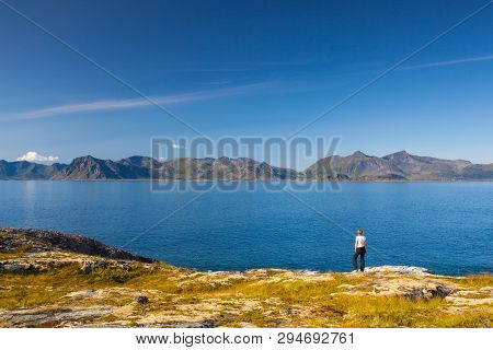 Henningsvaer,norway - August 19,2017: Lonely Women On The Coast Near The Henningsvaer Port On Lofote