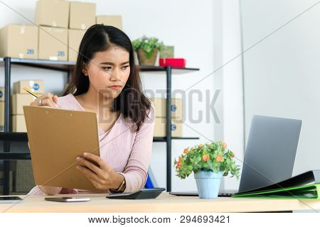 Shot Of Young And Beautiful Asian Business Lady In Casual Fashion Dress, Rechecking Purchase Order L