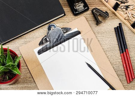 Folder, A Box, Pencil And Other Office Suplies On A White Desk