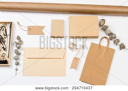Envelop, Labels, Bag, Paper And Other Office Suplies On A White Desk