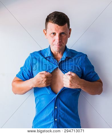 Businessman Tearing Off His Shirt And Showing Mucular Body Concept On Background