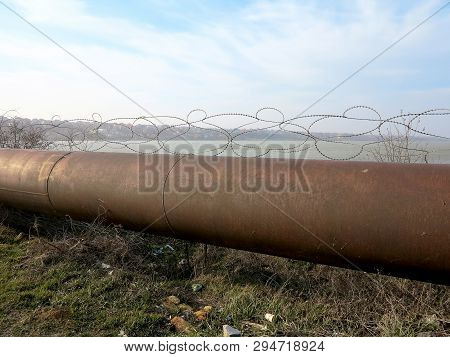 Pipeline. Large Iron Drainage Pipes Connect Two Reservoirs. Large Diameter Metal Pipe For Agricultur