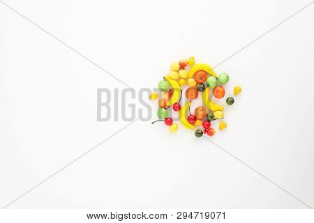 A Scattering Of Many Small Different Fruits On A White Background. Mini Copy, The Concept Of Diversi
