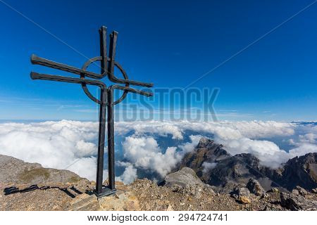 Summit Cross Of Uri Rotstock Mountain In Swiss Alps, Blue Sky, Sea Of Fog