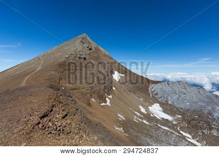 Summit Of Uri Rotstock Mountain In Swiss Alps, Natural Blue Sky, Sea Of Fog