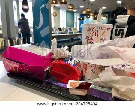 WEMBLEY, LONDON - APRIL 4, 2019: Paper and plastic fast food and drink wrappers and packaging inside a McDonalds restaurant in Wembley, North West London, UK.