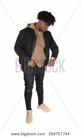 A Full Body Image Of An African American Man Standing In A Black 
Jacket And Jeans, Looking At His W
