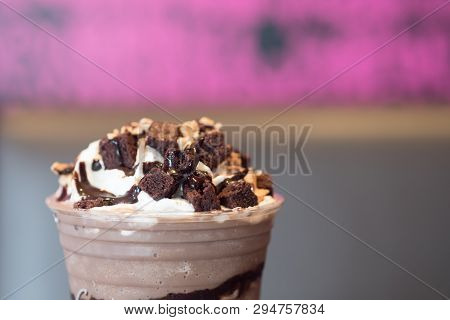 Whipping Cream With Chocolate And Brownies On Chocolate Frappe In Take Away Drink