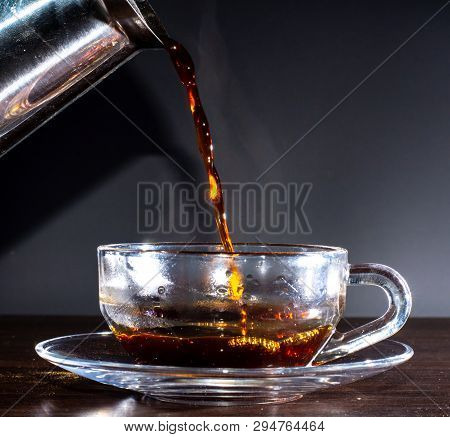Pouring Espresso From Moka Pot To Coffee Cup