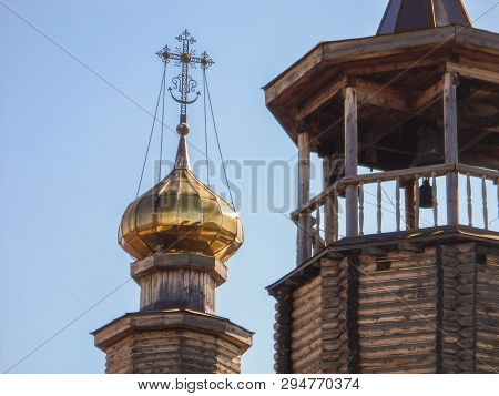 Dome With A Cross And Bell Tower Of A Wooden Temple. Russian Orthodox Church. Christianity. Religiou