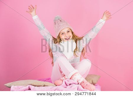 Keep Warm And Comfortable. Kid Girl Wear Knitted Hat Relaxing Pink Background. Child Long Hair Warm 