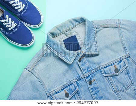 Retro Style Denim Stylish Jacket And Hipster Sneakers On A Mint-colored Paper Background. Minimalism