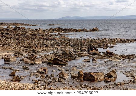 Beach With Rocks And Vegetation In Galway Bay