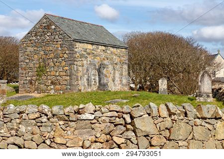 Stone House And Cemetery With Celtic Cross