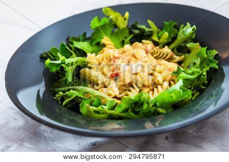 Salad made from radiatori cooked pasta, goat cheese and oil vinaigrette