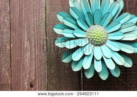 Teal Or Blue Rusty Metal Flower On Fence