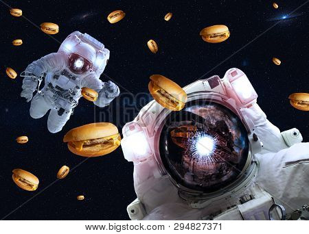 Astronauts In Outer Space With Cheseburgers. Elements Of This Image Furnished By Nasa. Suitable For 