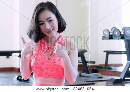Health Care Healthy Lifestyle Concept. Attractive Young Woman Showing Thumbs Up After Workout In Gym