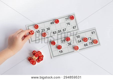 Bingo Or Lotto Game. Wooden Kegs Of Lotto On Cards. Cards And Chips For Playing Bingo On A White Tab