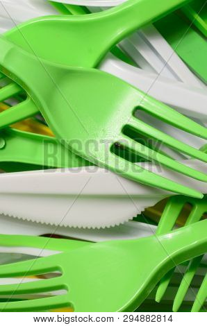 Pile Of Bright Yellow, Green And White Used Plastic Kitchenware Appliances