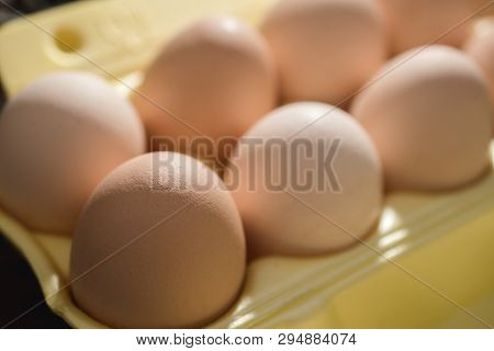 Chicken Eggs Lie In A Yellow Plastic Tray.