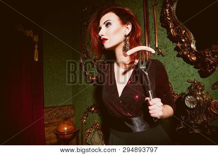 A portrait of a beautiful woman posing in the vintage interior and having a meal. Beauty, fashion, interior.