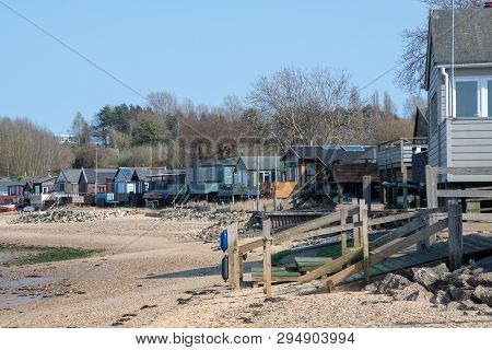 Maningtree Suffolk Uk  - 1 April  2019:  Row Of Large Wooden Beachside Homes On Beach