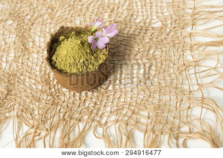 Henna Powder For Dyeing Hair And Eyebrows And Drawing Mehendi On Hands, Isolate With Green Palm Leaf