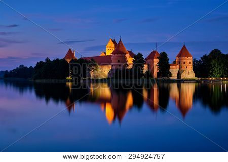 Night view of Trakai Island Castle in lake Galve illuminated in the evening, Lithuania