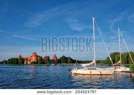 Yacht boats and Trakai Island Castle in lake Galve in day, Lithuania. Trakai Castle is one of major tourist attractions of Lituania