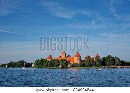 Trakai Island Castle in lake Galve with boats and yachts in summer day with beautiful sky, Lithuania. Trakai Castle is one of major tourist attractions of Lituania