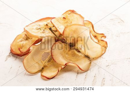 Heap Of Dried Apple Chips On White Textured Background. Fruit Chips, Healthy Snack.