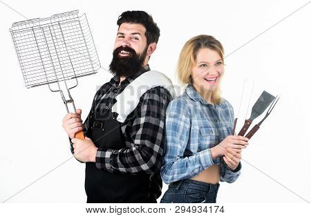Couple In Love Hold Cooking Utensils Barbecue. Tools For Roasting Meat Outdoors. Picnic And Barbecue