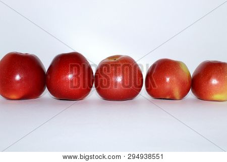 Five Red Apples Stand Tall In A Row On A White Background