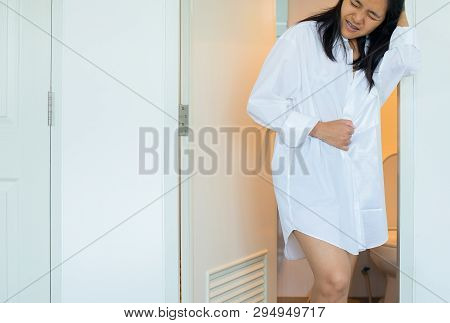Asian Woman Using Toilet And Suffers From Diarrhea And  Hemorrhoids After Wake Up In Morning At Hous