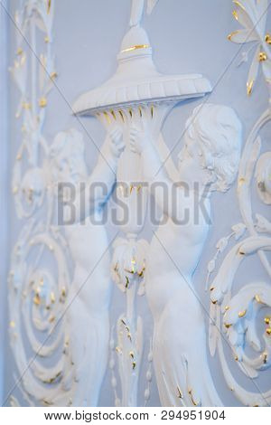 The Blue Wall Is Decorated With White Decorative Plaster With Exquisite Patterns.