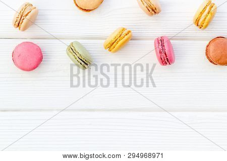 Brignt Macarons For Sweet Break On White Wooden Background Top View Mock Up