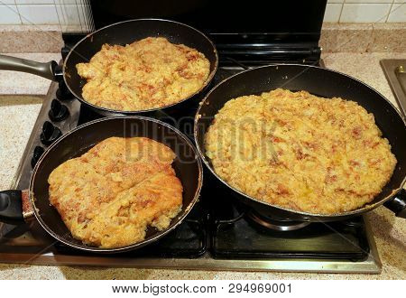 Three Pots Of Frico A Typical Italian Food Of Friuli Region In Italy Made With Cheese And Potatoes