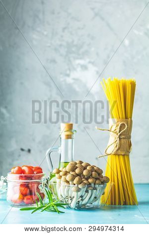 Spaghetti, Shimeji Mushroom, Olive Oil,  Pink Salt, Empty Ceramic Bowl, Wooden Spoons For Salad Over