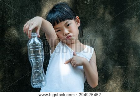 Child Girl Is Holding A Plastic Bottle