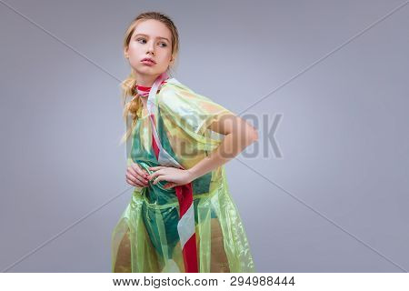 Blonde-haired Young Woman Posing With White And Red Strip On Neck