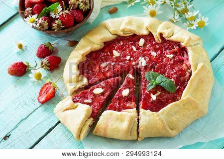 Fresh Homemade Strawberries Galette With Nut Cream On The White Kitchen Table.