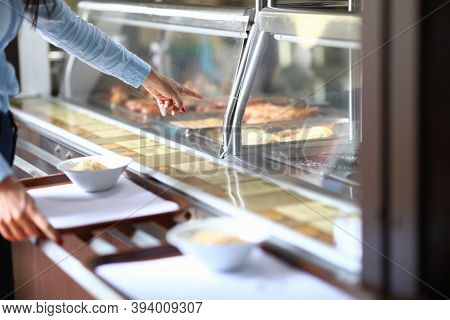 Woman In Cafe Points To Dinner Dish On Salad Tray. Self Service In Bistro And Cafe Concept
