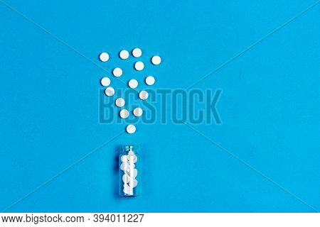 Jar With Medicines, White Pharmaceutical Pills On A Blue Background. Svehu View.