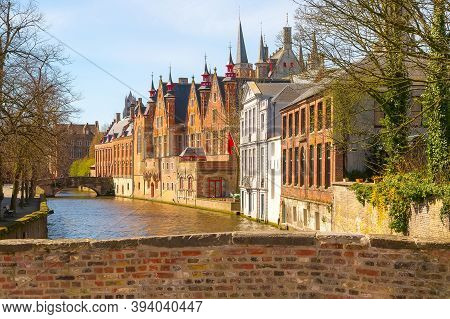 Bruges, Belgium Historic Medieval Brick Houses With Towers Street View Along Groene Rei Canal