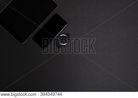 Overhead Shot Of A Smartwatch, Smartphone And A Tablet On A Black Background. Wireless Technology Co