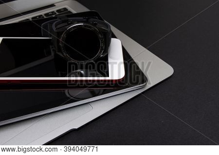 Close-up Of A Smartwatch, Smartphone, Tablet And Laptop On Black Background. Wireless Technology Con